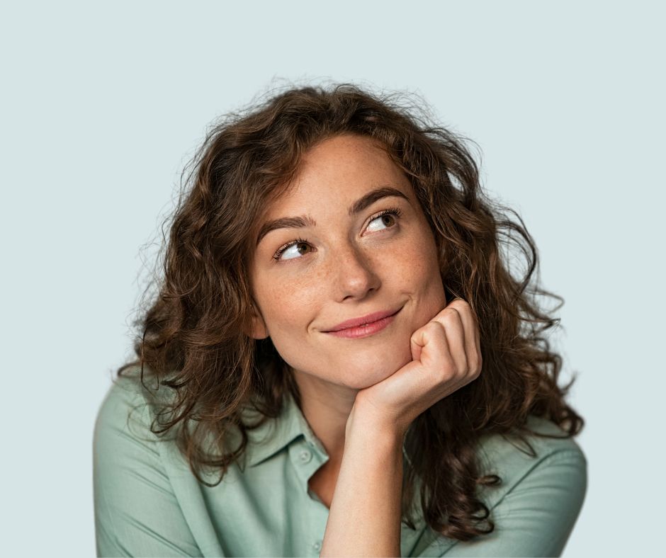 A woman with curly hair gazing upwards.