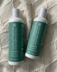 Vegan hair care set: duo of shampoo and conditioner displayed on a blanket.