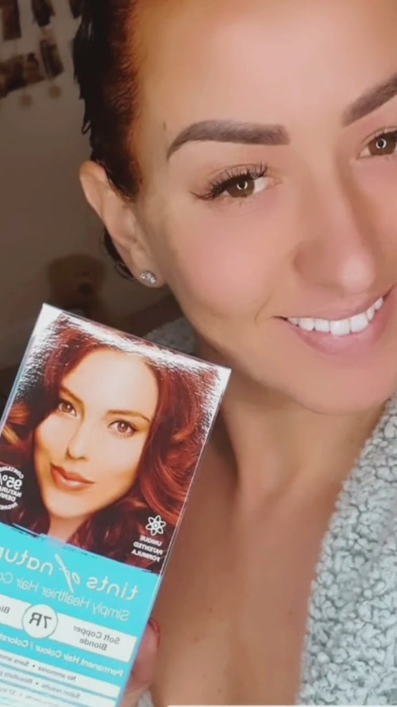 Video of happy woman using Tints of Nature 7R Permanent Hair Dye. 